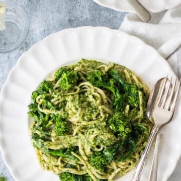 Parsley pea pesto on a white dish with a gray background.