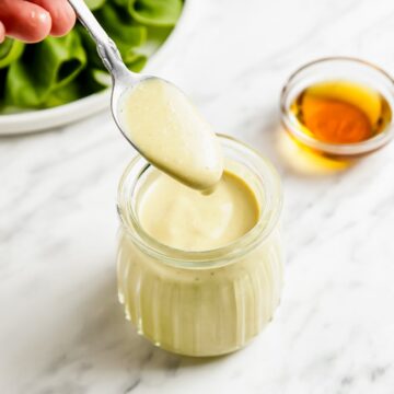 Vegan Honey Mustard Sauce with a white marble background.