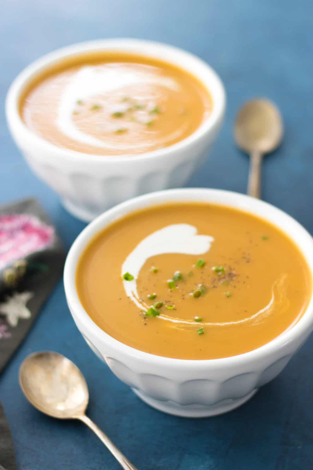side shot of the butternut soup with a golden spoon