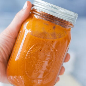 Homemade gluten-free enchilada sauce in a glass jar.
