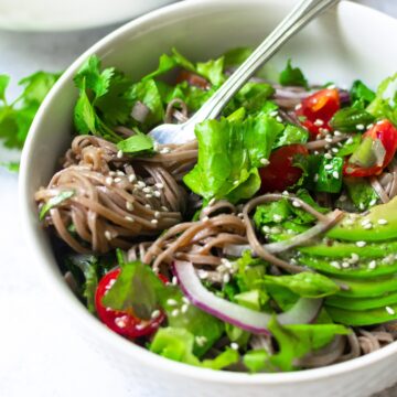 Buckwheat soba noodle salad in a white bowl.