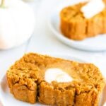 slice of pumpkin bread with butter and white pumpkin in background