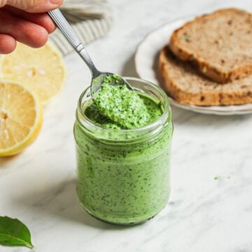 Fresh vegan pesto in a glass jar.