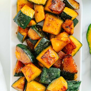 Easy Kabocha Squash (roasted) on a white platter with a white background.