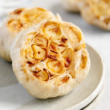 Air fryer roasted garlic on a plate.