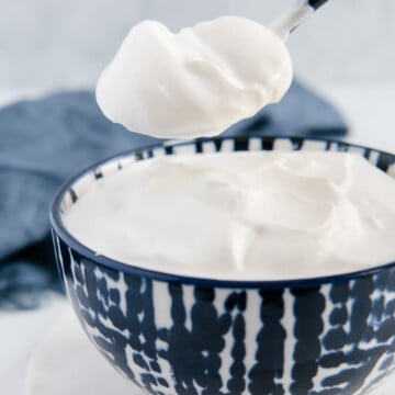 Vegan sour cream in a dark blue and white bowl.