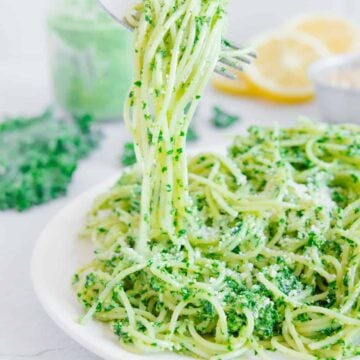 Pasta al pesto on a white plate.