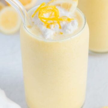 Vegan Lemon Smoothie garnished with coconut whipped cream and lemon zest.