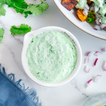Homemade creamy cilantro sauce in a white bowl.