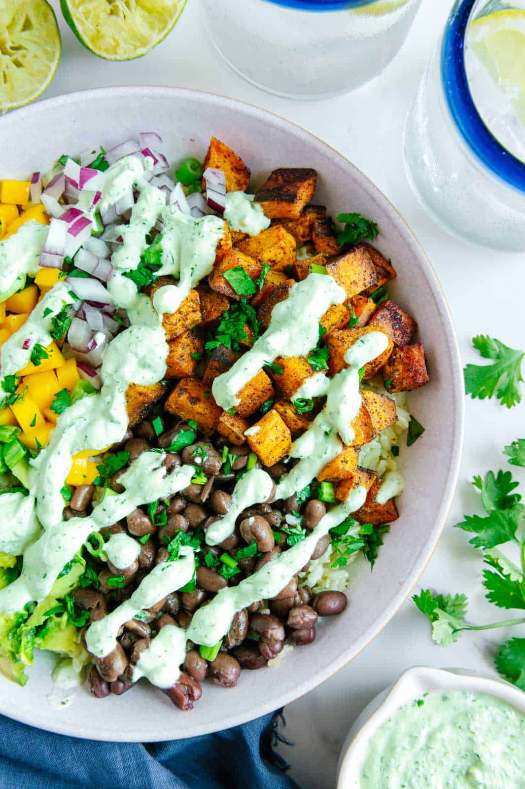 Vegan taco bowl topped with creamy cilantro lime sauce.