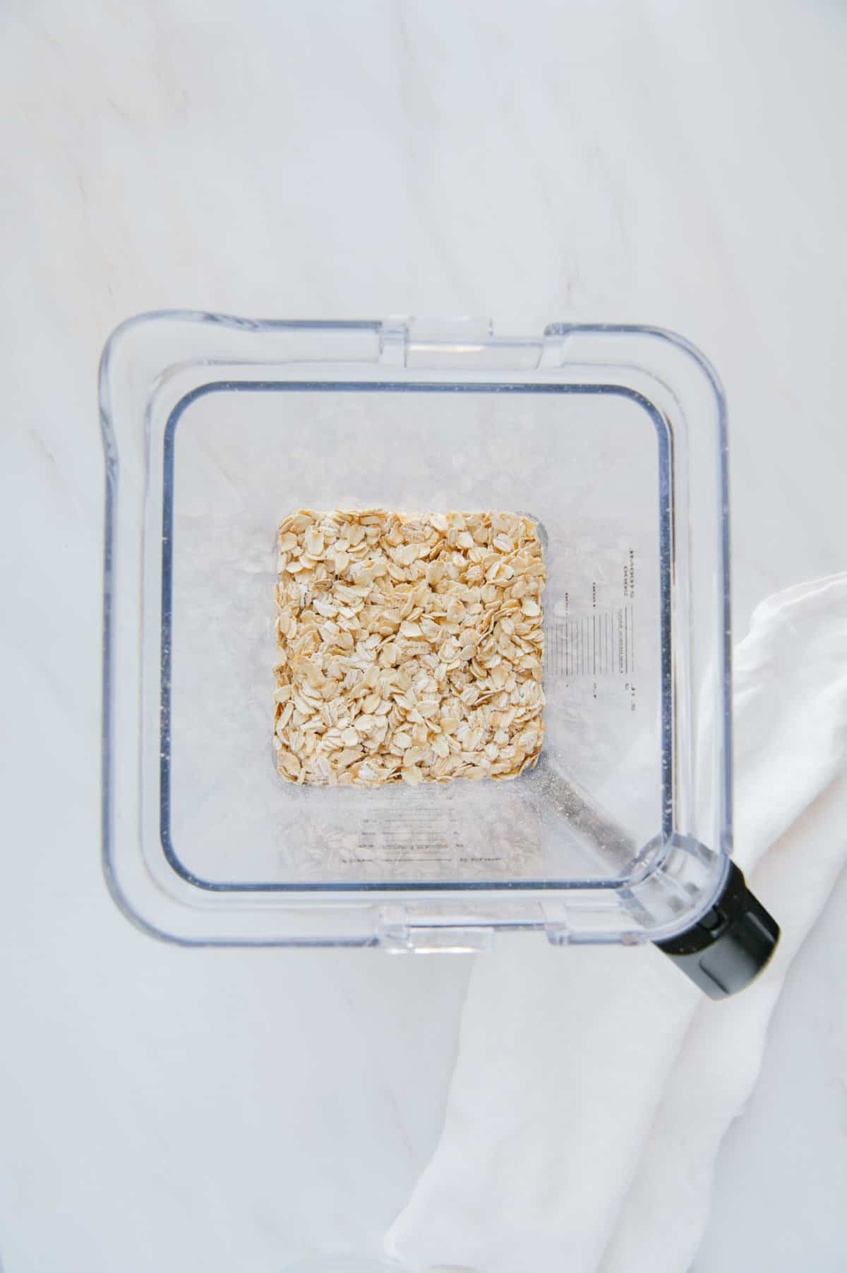 Oats in a blender with a white background.