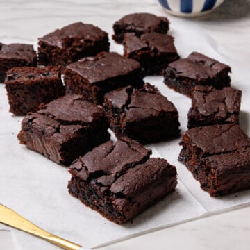 Black bean brownies on a white paper towel with a white background.
