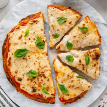 Vegan and Gluten-Free Cheese Pizza with a white background.