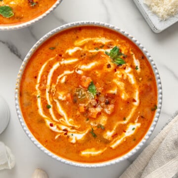 Vegan tomato and black lentil soup in a white bowl.