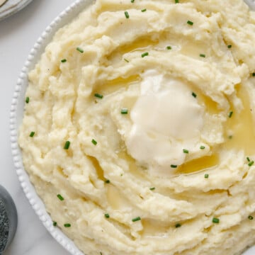 Dairy-free mashed potatoes in a white bowl with a white background.