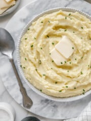 Dairy-free mashed potatoes in a white bowl with a white background.