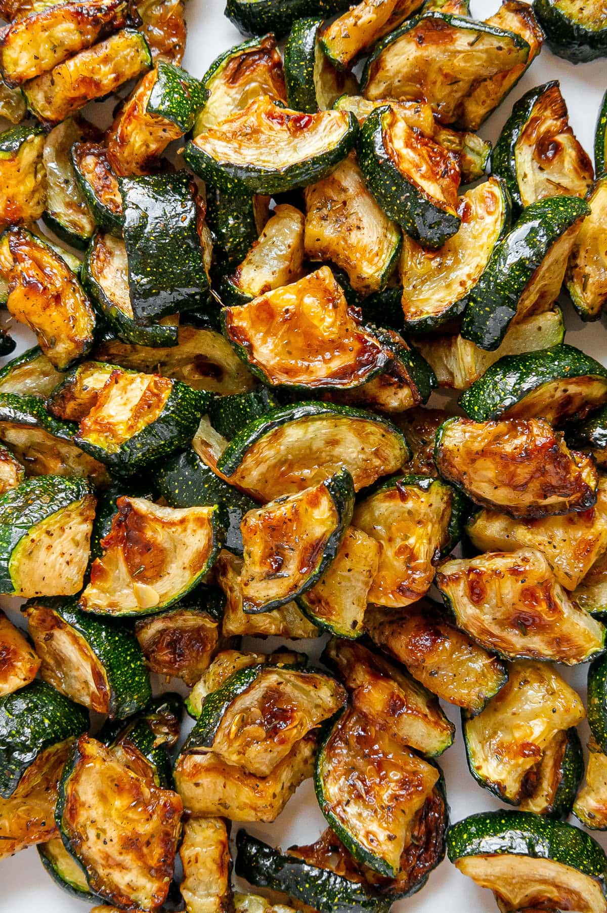 Crispy air fryer zucchini pieces piled together.