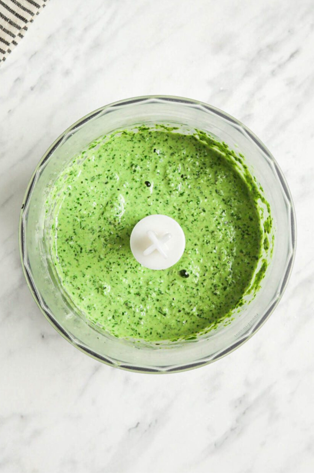 Pesto in a food processor once fully blended.