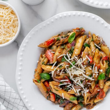 Pasta fresca served in a white bowl with a white marble background.