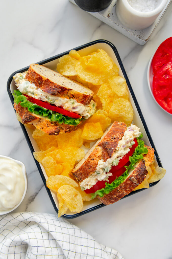 Chickpea sandwiches with mayo served on platter with potato chips