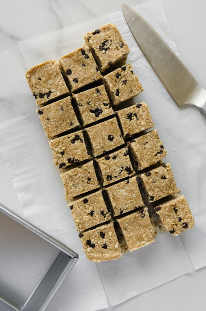 Homemade Heavenly Hunks sliced into chunks on white parchment paper.
