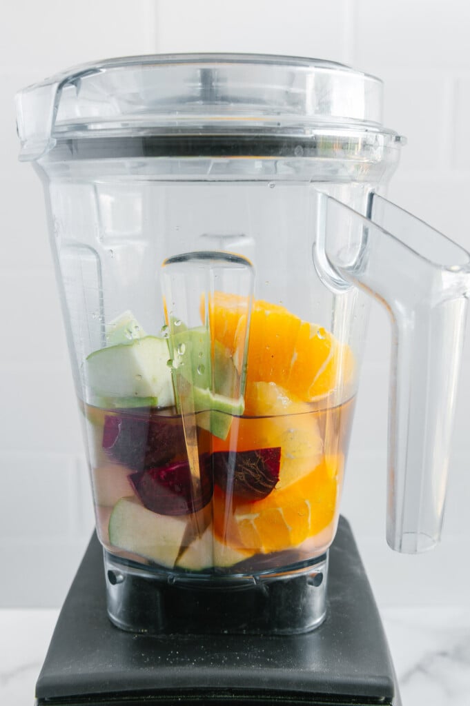 Fruit and water in a blender prior to blending.