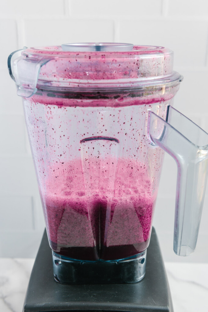 Blueberry lemonade in a blender after blending the ingredients.