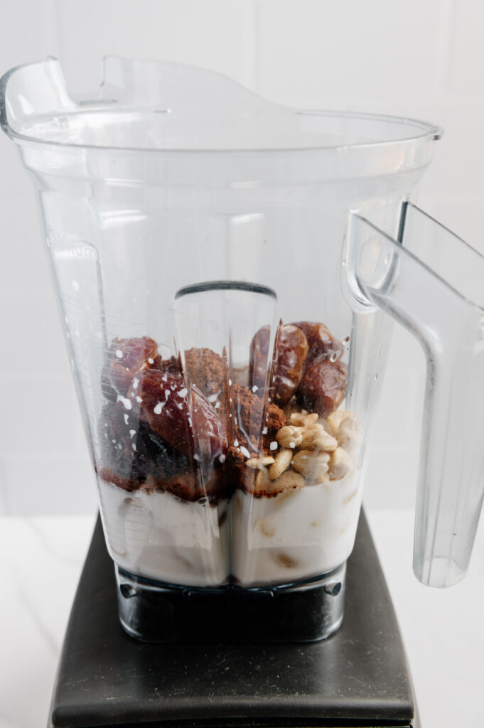 Vegan chocolate milkshake ingredients in a blender prior to blending.