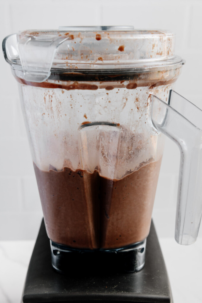 Vegan chocolate milkshake in a blender after blending all ingredients.