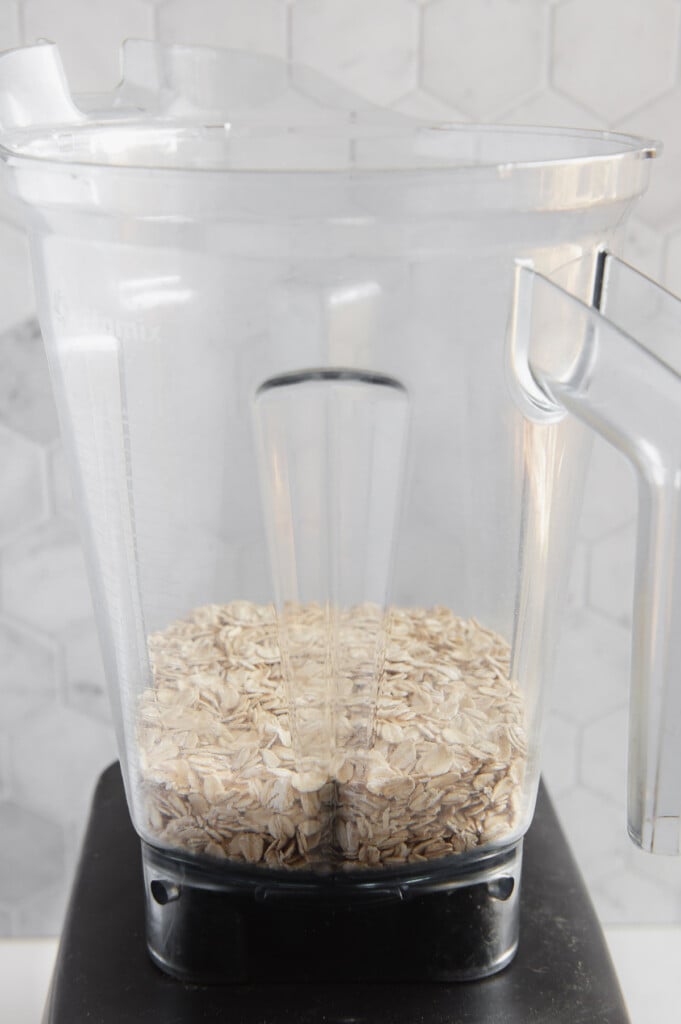 Oats in a blender with a white background.