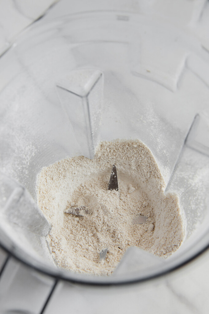 A close up shot of oat flour in a blender.