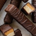 Homemade Twix bars arranged with two of them sliced in half to see the filling.