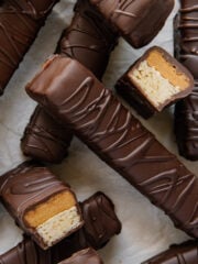 Homemade Twix bars arranged with two of them sliced in half to see the filling.