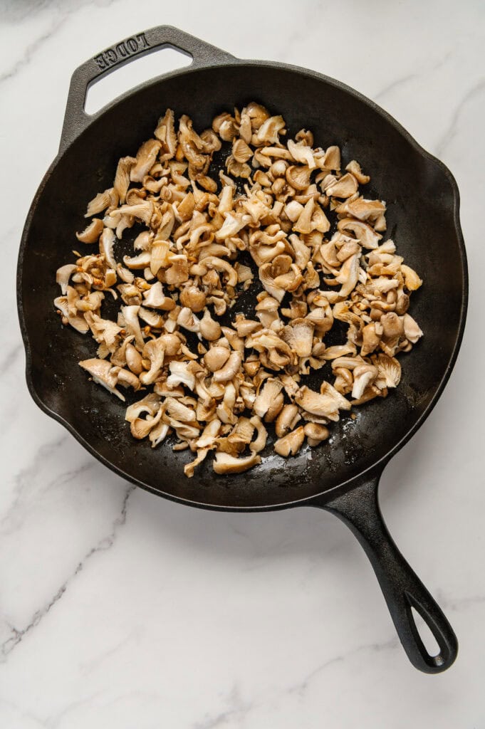 Chopped blue oyster mushrooms in a skillet prior to sautéing.