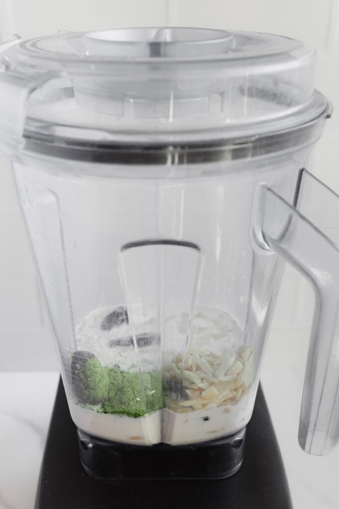 Matcha smoothie ingredients in a blender prior to blending.