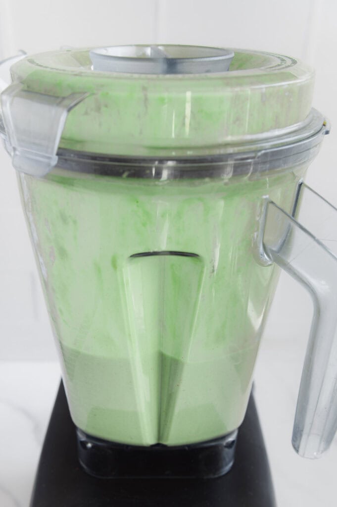 Matcha smoothie in a blender after blending.