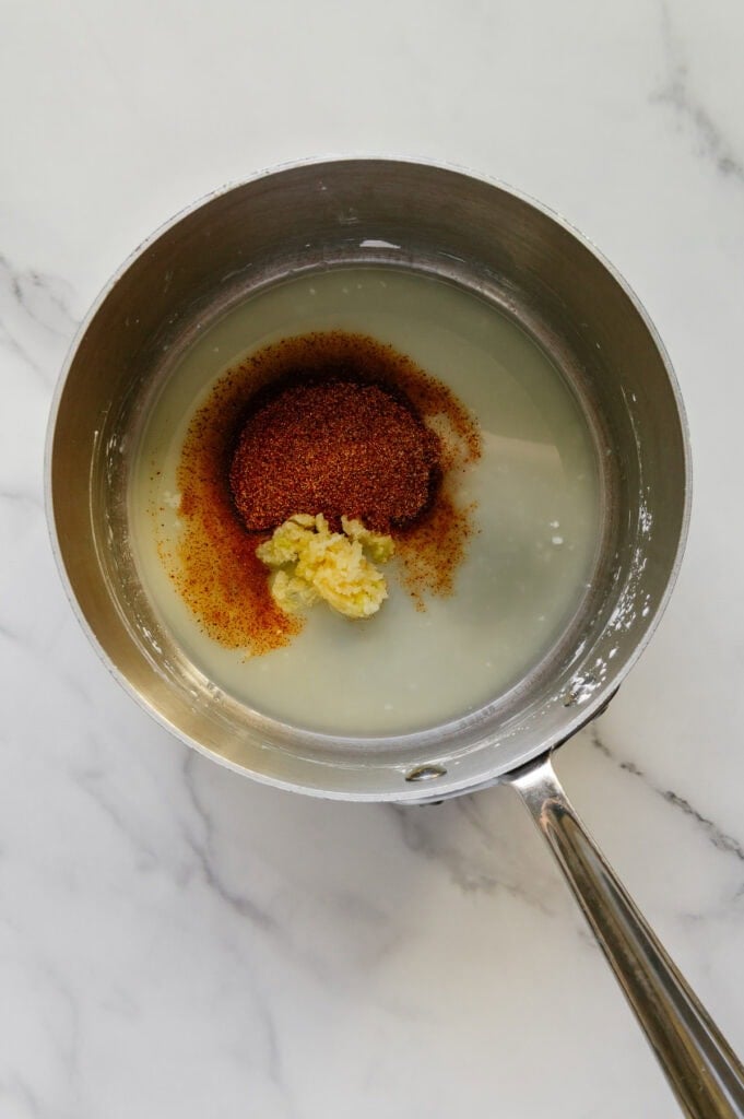 Pressed garlic and seasonings in a saucepan of olive oil and arrowroot powder.